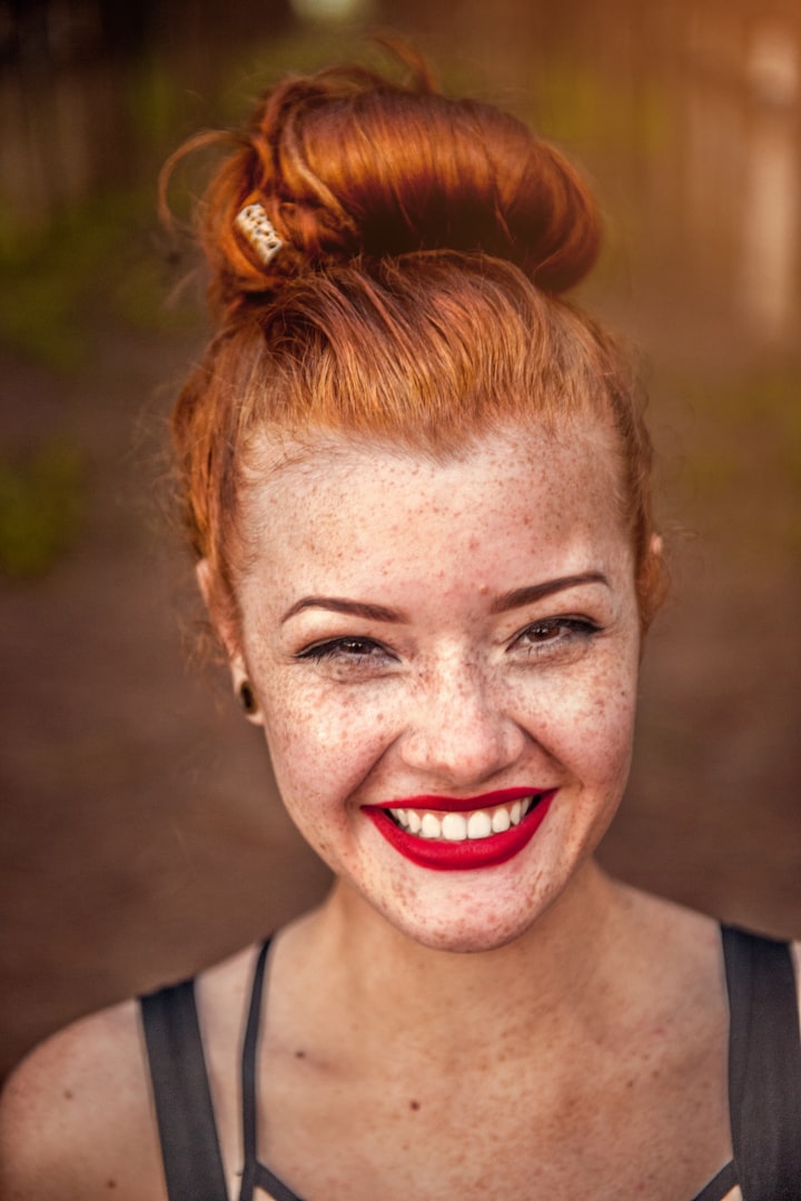 Close up of one women with red hair and smiling