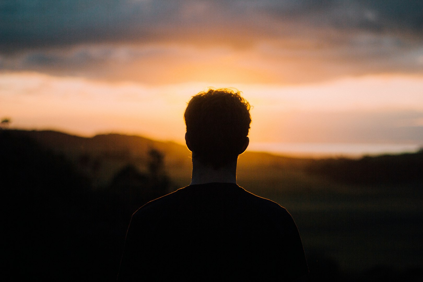 One man looking into the sunset at dawn